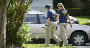 FBI personnel walk through the complex surrounding the apartment, where Ibragim Todashev, 27, was shot and killed by FBI